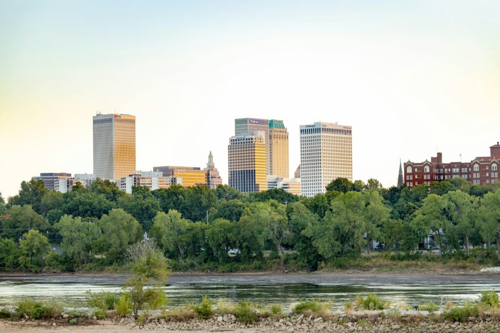 a city skyline with trees and water from 12 Affordable Places To Travel In US